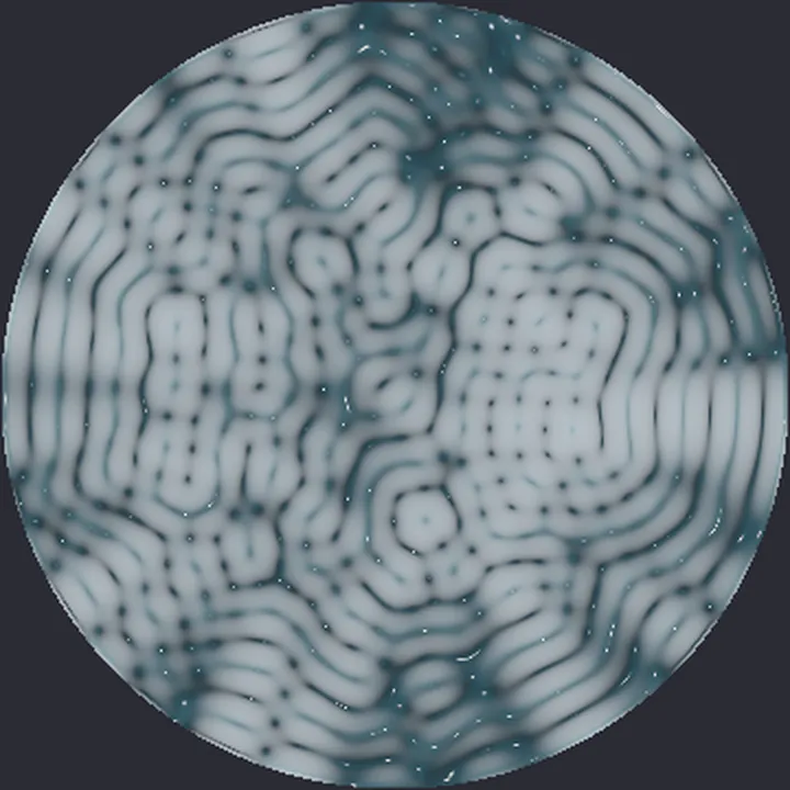 A circular dish of simulated water seen from above, its pale surface broken into wavy rows and small cells.