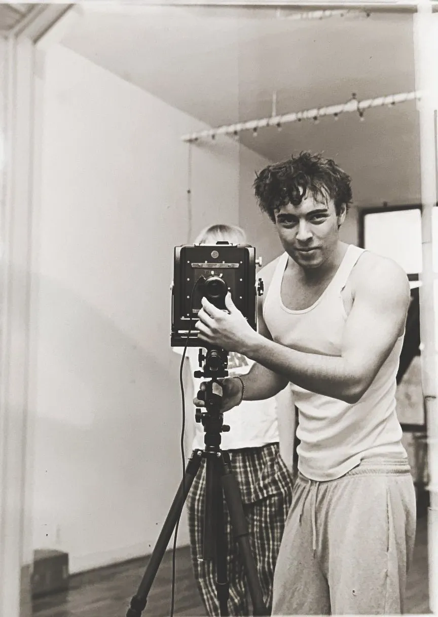 Black and white mirror self-portrait with a large format camera on a tripod