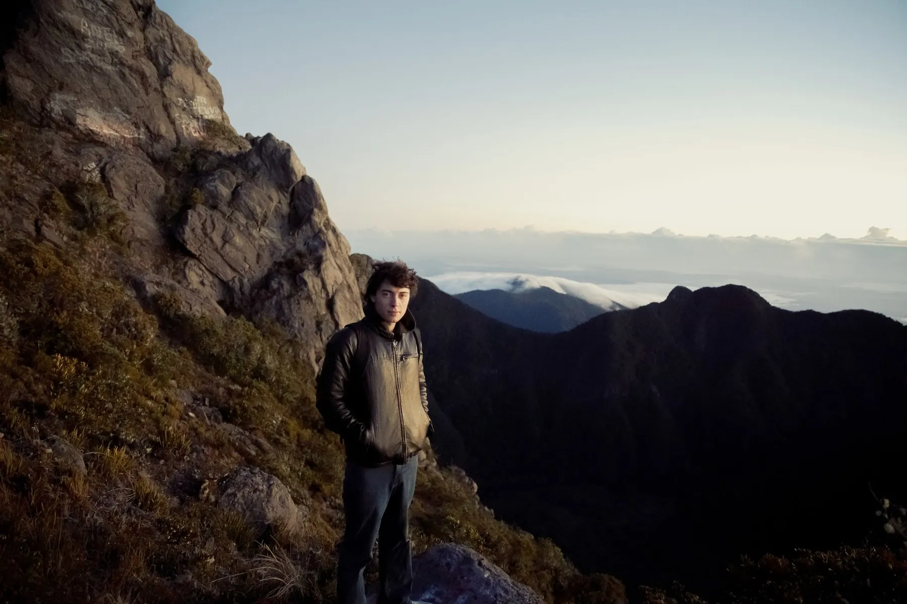 Luke on a mountain ridge at sunrise, above the clouds